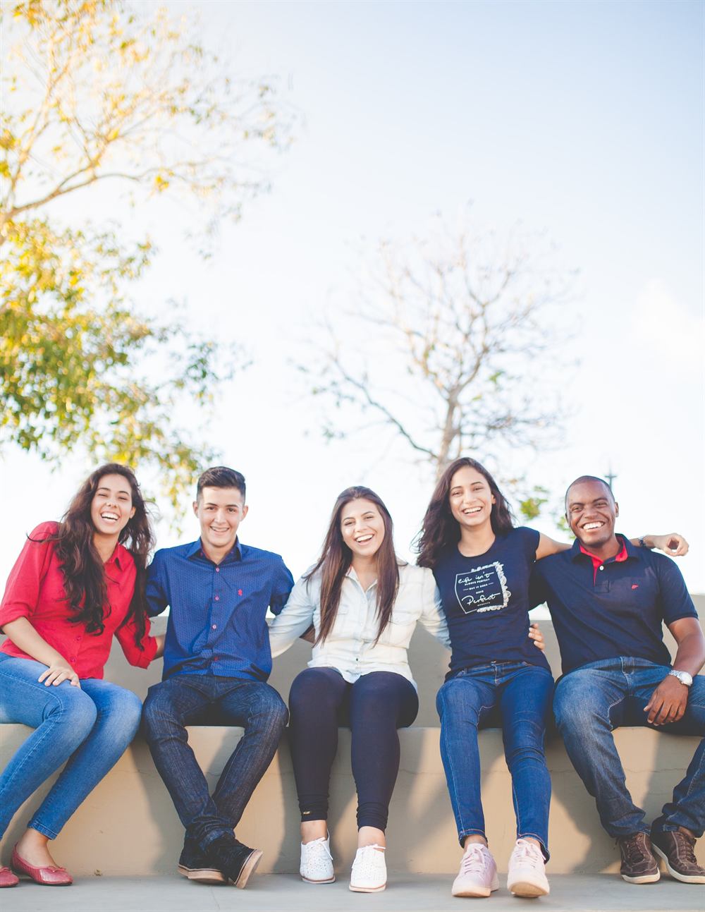 A diverse group of young people smiling together