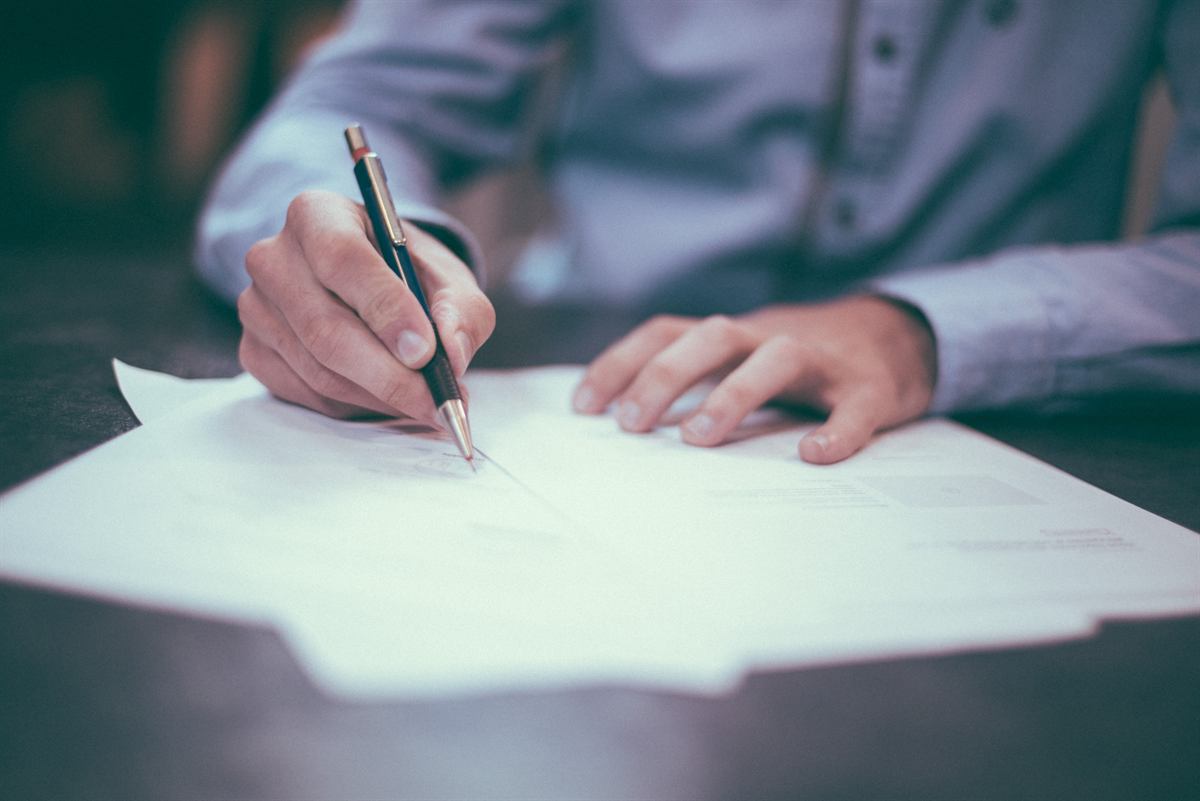 Hands reviewing and signing documents