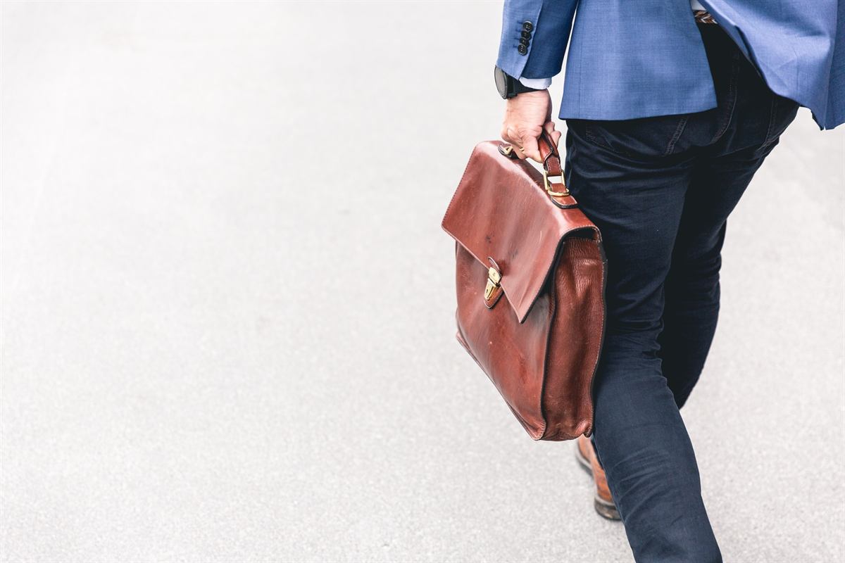 A professional walking to work with a briefcase